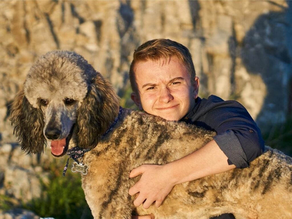 Boy hugging Poodle (1), Poodle Temperament, Poodle Traits, Poodle Size and Appearance