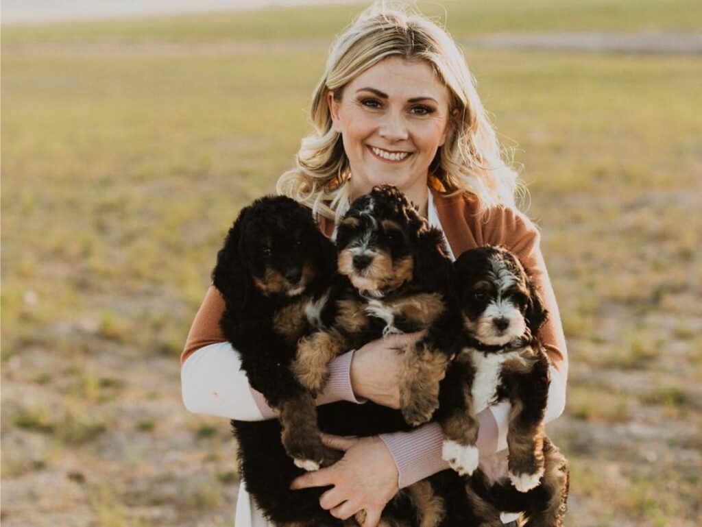 Reputable dog breeder interacting with well-socialized puppies